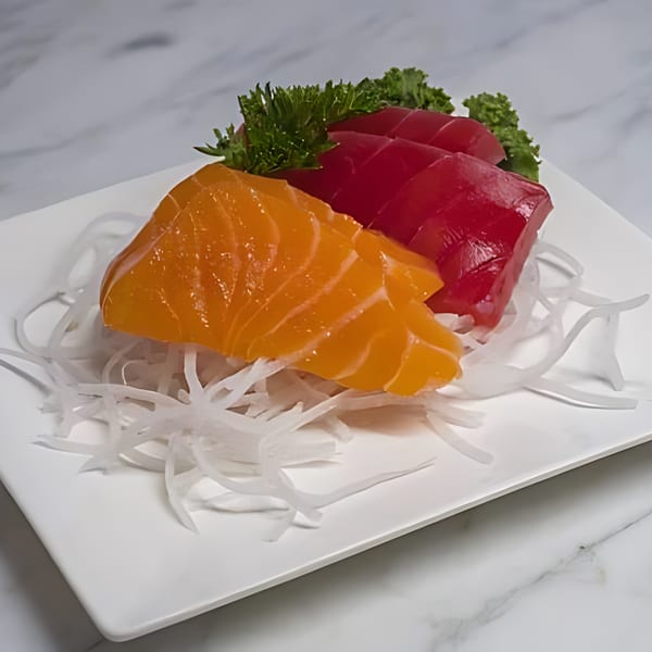 Min Sushi's salmon and tuna sashimi slices, garnished with parsley and daikon radish.
